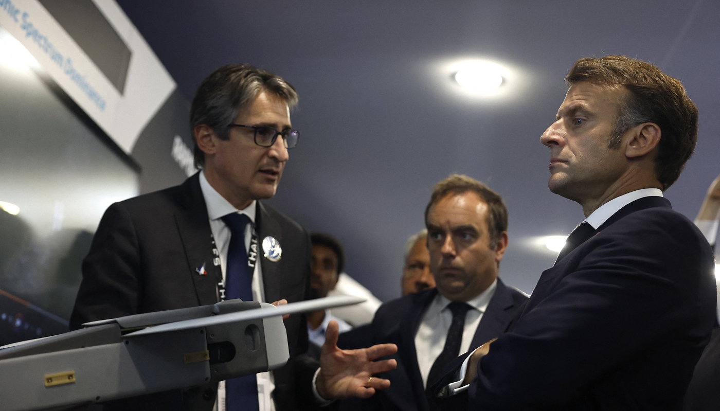Patrice Caine, PDG de Thales, Emmanuel Macron, président de la République française, et Sébastien Lecornu (arrière-plan), alors ministre des armées, depuis devenu premier ministre, le 20 juin 2025, au Bourget, lors du Salon international de l'aeronautique et de l'espace.