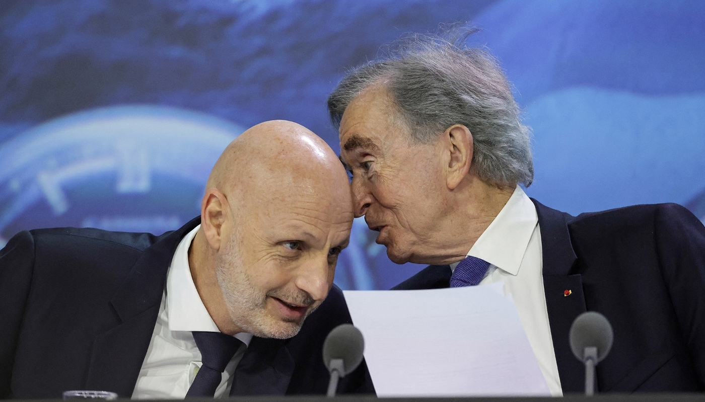 LVMH chairman and CEO Bernard Arnault (R) speaks with LVMH deputy chief executive officer Stéphane Bianchi (L) as they attend the annual general meeting of the world's leading luxury group LVMH at the Carrousel du Louvre in Paris on April 23, 2026.