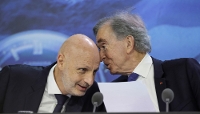 LVMH chairman and CEO Bernard Arnault (R) speaks with LVMH deputy chief executive officer Stéphane Bianchi (L) as they attend the annual general meeting of the world's leading luxury group LVMH at the Carrousel du Louvre in Paris on April 23, 2026.
