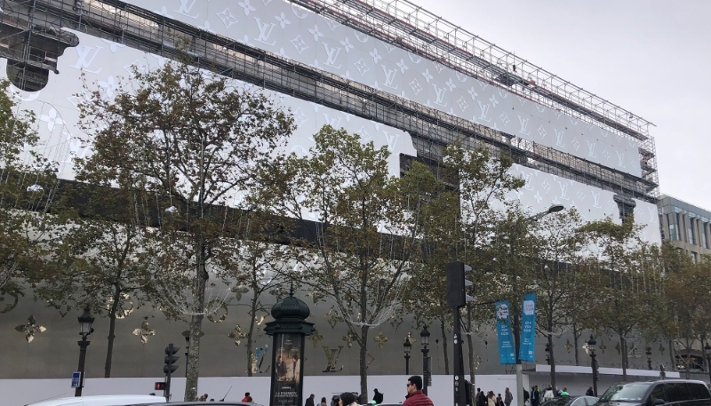 La façade publicitaire en forme de malle géante qui recouvre la quasi-totalité du chantier de la nouvelle adresse Louis Vuitton sur les Champs-Élysées.